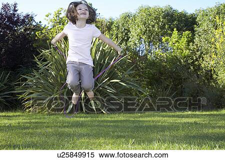 Stock Photography - Young girl jumping in the air. Fotosearch