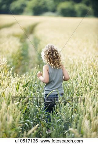 Young girl walking path in cornfield View Large Photo Image Stock Photography - Young girl walking path in cornfield. Fotosearch