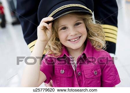 Young girl wearing flight captain's hat View Large Photo Image Stock Image - Young girl wearing flight captain's hat. Fotosearch
