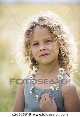 Young girl with daisy chain necklace View Large Photo Image Stock Photo - Young girl with daisy chain necklace. Fotosearch