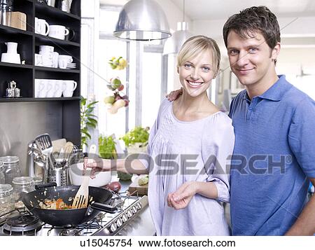 Man and woman in kitchen cooking food View Large Photo Image Picture - Man and woman in kitchen cooking food. Fotosearch