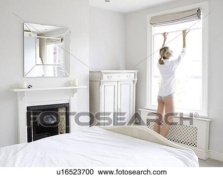 Stock Image - Woman in bedroom. Fotosearch