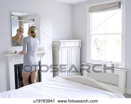 Stock Image - Woman in bedroom. Fotosearch
