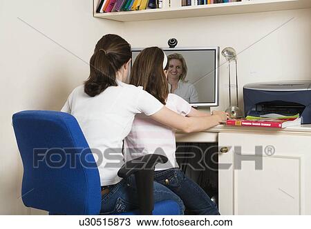 Stock Image - Children talking to mother on skype. Fotosearch