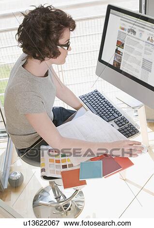 Female designer working at her computer View Large Photo Image Stock Photo - Female designer working at her computer. Fotosearch