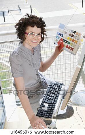 Female designer working at her computer View Large Photo Image Stock Photography - Female designer working at her computer. Fotosearch