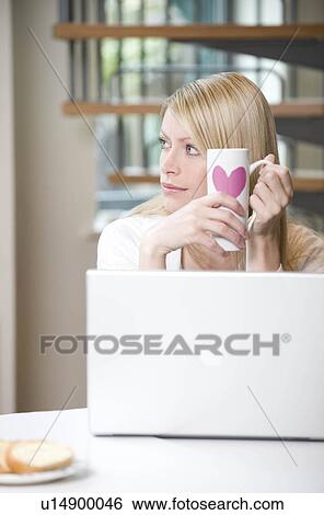 Female has a working breakfast View Large Photo Image Stock Photograph - Female has a working breakfast. Fotosearch
