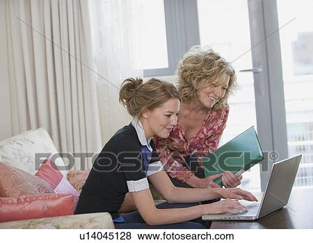 Mother and daughter on the laptop View Large Photo Image Stock Photo - Mother and daughter on the laptop. Fotosearch