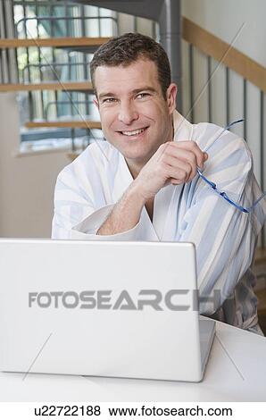 Portrait of a male at his laptop View Large Photo Image Stock Photo - Portrait of a male at his laptop. Fotosearch