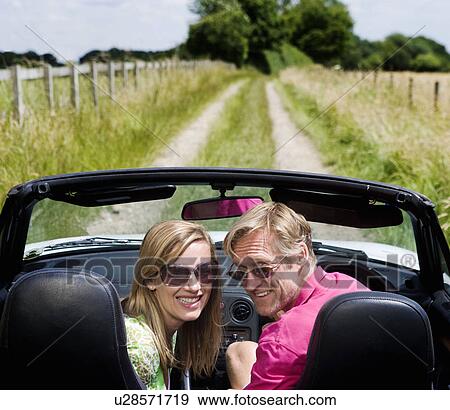 Couple in convertible car View Large Photo Image Stock Photo - Couple in convertible car. Fotosearch