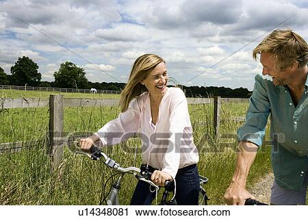 Couple on cycles View Large Photo Image Stock Image - Couple on cycles. Fotosearch