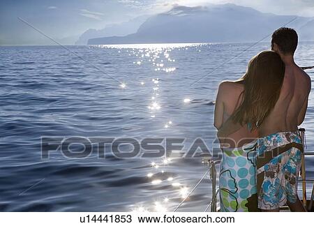Couple on sailboat at sunset View Large Photo Image Stock Image - Couple on sailboat at sunset. Fotosearch