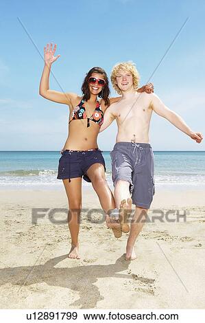 Couple playing beach game View Large Photo Image Stock Photo - Couple playing beach game. Fotosearch