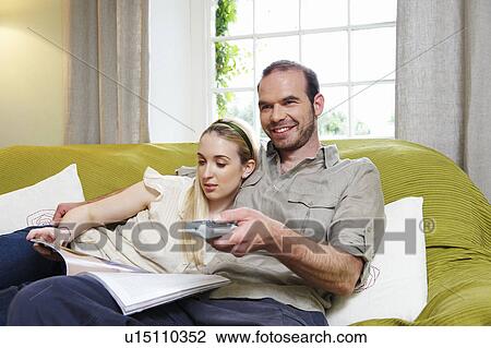 Couple sitting on couch View Large Photo Image Stock Image - Couple sitting on couch. Fotosearch