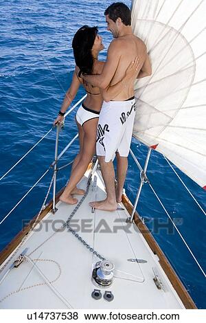 Couple standing on sail boat View Large Photo Image Stock Photo - Couple standing on sail boat. Fotosearch