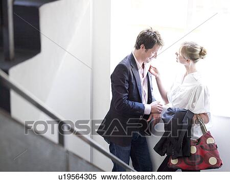 Stock Photography - Man and woman on stairs together. Fotosearch