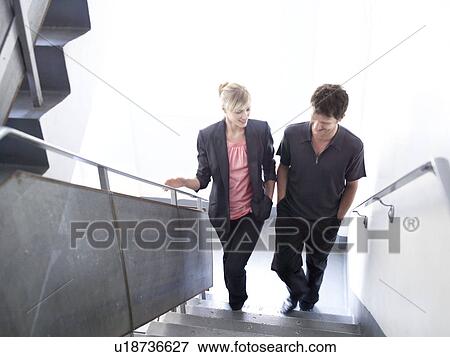 Man and woman walking up stairs View Large Photo Image Stock Photo - Man and woman walking up stairs. Fotosearch