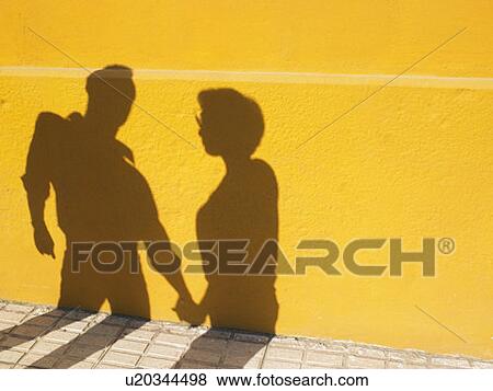 Shadows of a couple holding hands. View Large Photo Image Stock Photo - Shadows of a couple holding hands.. Fotosearch