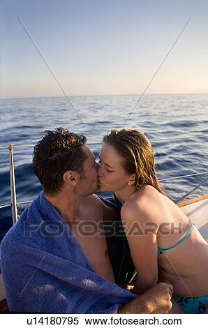 Young couple kissing on sailboat View Large Photo Image Stock Photography - Young couple kissing on sailboat. Fotosearch