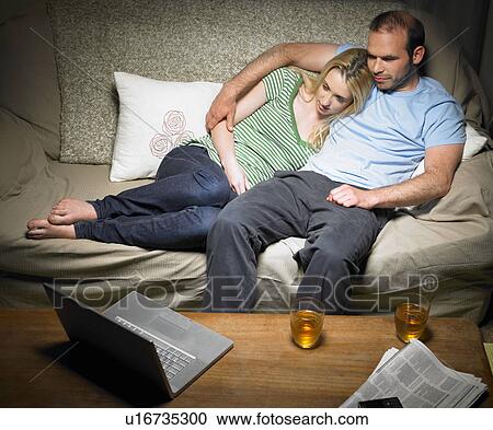 Young couple watching a movie View Large Photo Image Stock Image - Young couple watching a movie. Fotosearch