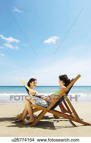 Young women sitting in the sun View Large Photo Image Picture - Young women sitting in the sun. Fotosearch