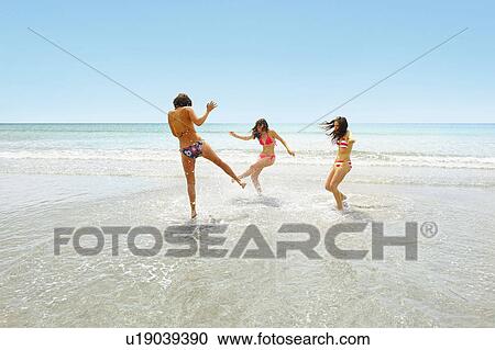 Three girls splashing each other View Large Photo Image Stock Image - Three girls splashing each other. Fotosearch