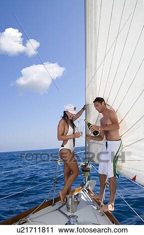 Couple drinking champagne, sailboat View Large Photo Image Stock Image - Couple drinking champagne, sailboat. Fotosearch