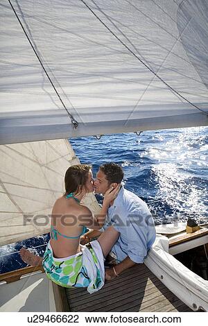 Couple kissing on sailboat View Large Photo Image Stock Image - Couple kissing on sailboat. Fotosearch