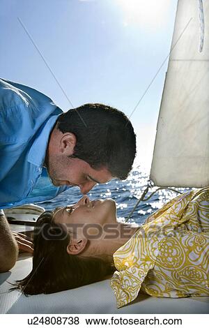 Couple on sailboat, face to face View Large Photo Image Stock Photo - Couple on sailboat, face to face. Fotosearch
