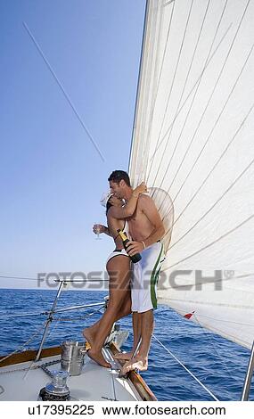 Couple on sailboat, with champagne View Large Photo Image Stock Photography - Couple on sailboat, with champagne. Fotosearch