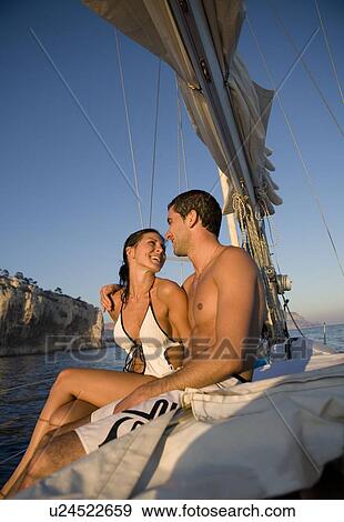 Couple smiling to each other on boat View Large Photo Image Stock Photo - Couple smiling to each other on boat. Fotosearch