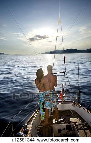 Couple watching sunset on sailboat View Large Photo Image Picture - Couple watching sunset on sailboat. Fotosearch
