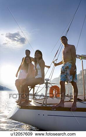 Group on back of sailboat smile View Large Photo Image Stock Photo - Group on back of sailboat smile. Fotosearch