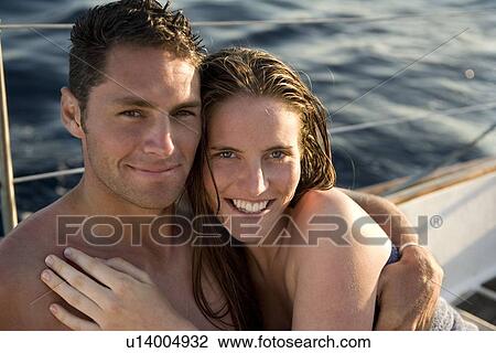 Young couple on sailboat, smiling View Large Photo Image Stock Image - Young couple on sailboat, smiling. Fotosearch