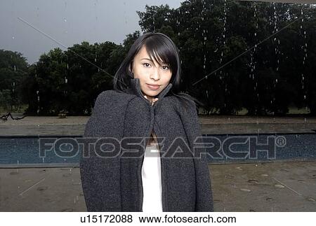 Stock Photo - Portrait of a woman under the rain. Fotosearch