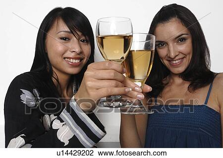 Stock Image - Two women having a drink. Fotosearch