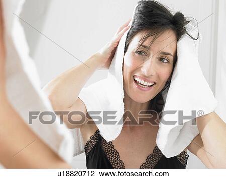 Woman drying her hair View Large Photo Image Stock Image - Woman drying her hair. Fotosearch
