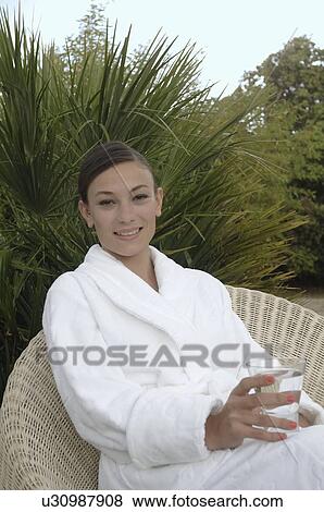 Woman having a drink outdoors View Large Photo Image Stock Photo - Woman having a drink outdoors. Fotosearch