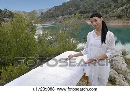 Woman in front of a massage table View Large Photo Image Stock Photo - Woman in front of a massage table. Fotosearch