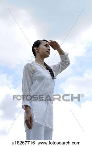 Woman looking at the horizon View Large Photo Image Stock Photograph - Woman looking at the horizon. Fotosearch