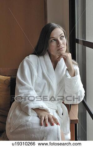Stock Photograph - Woman looking at window. Fotosearch