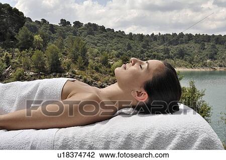 Woman lying down on massage table View Large Photo Image Stock Image - Woman lying down on massage table . Fotosearch