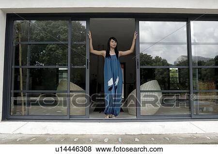 Woman opening front door View Large Photo Image Stock Photo - Woman opening front door. Fotosearch