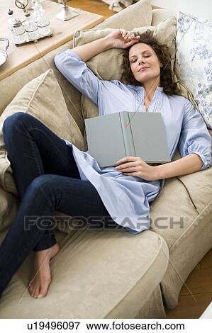 Stock Photo - Woman sleeping on a couch. Fotosearch
