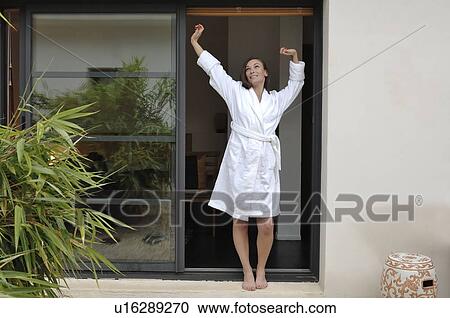 Woman stretching by door View Large Photo Image Stock Image - Woman stretching by door. Fotosearch