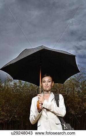 Woman under an umbrella View Large Photo Image Stock Image - Woman under an umbrella. Fotosearch