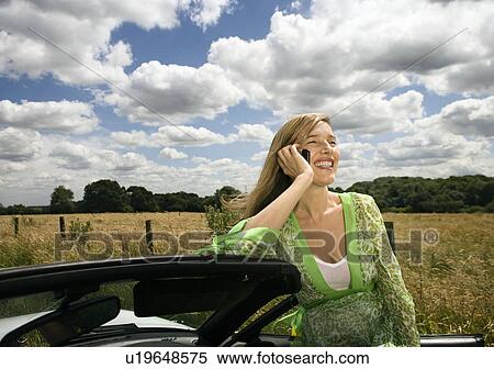 Stock Photography - Women on mobile phone, by car. Fotosearch