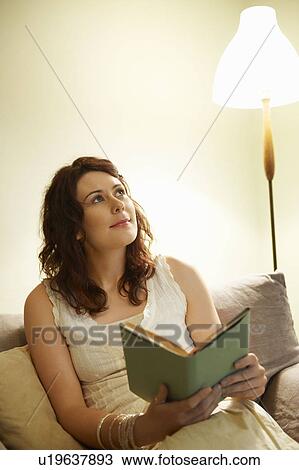 Young woman holding book View Large Photo Image Stock Image - Young woman holding book. Fotosearch
