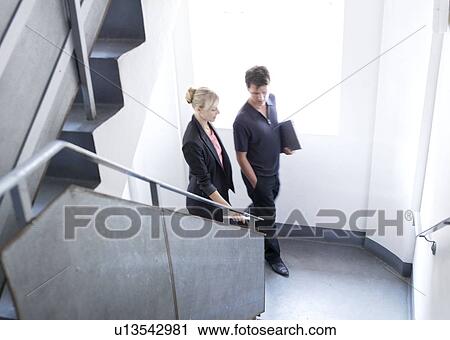 Man and woman walking up stairs View Large Photo Image Stock Image - Man and woman walking up stairs. Fotosearch