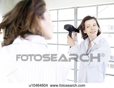 Woman in mirror applying make up View Large Photo Image Picture - Woman in mirror applying make up. Fotosearch